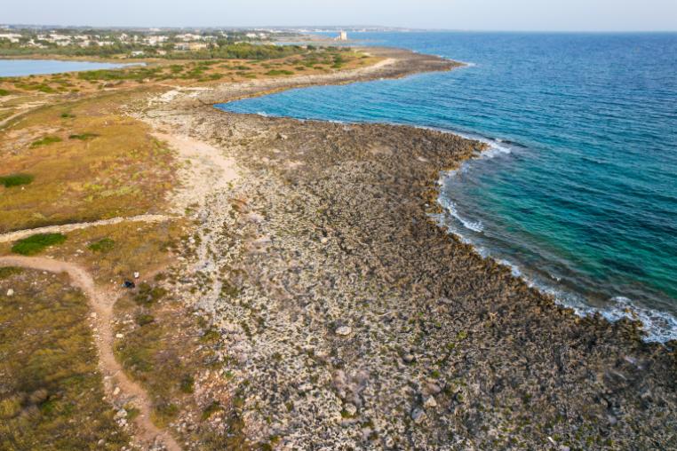 Looking along the shore at Porto Cesareo, the sea is on the right and the shore on the right.